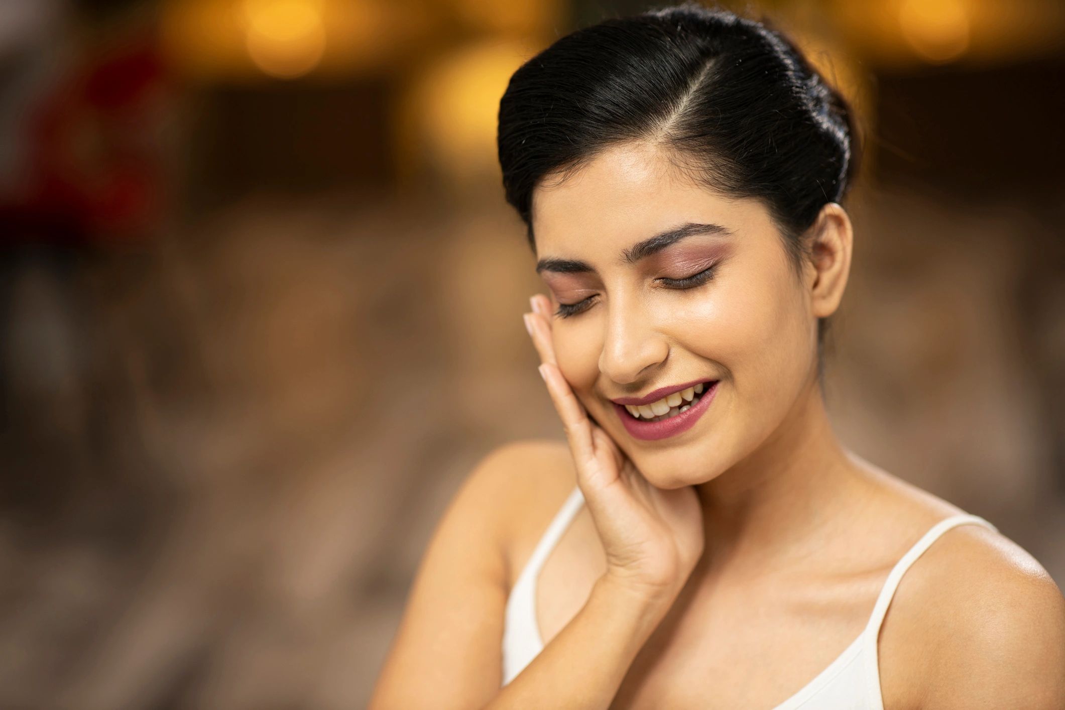 Woman applying a small amount of skincare cream